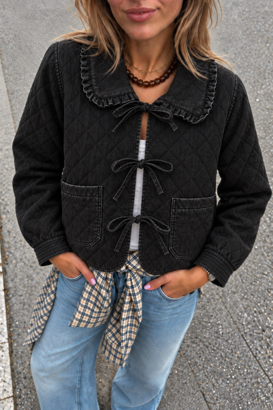 Woman wearing Chloe black tie-front quilted denim jacket with lace-trimmed collar
