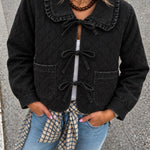 Woman wearing Chloe black tie-front quilted denim jacket with lace-trimmed collar