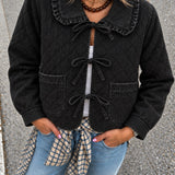 Woman wearing Chloe black tie-front quilted denim jacket with lace-trimmed collar