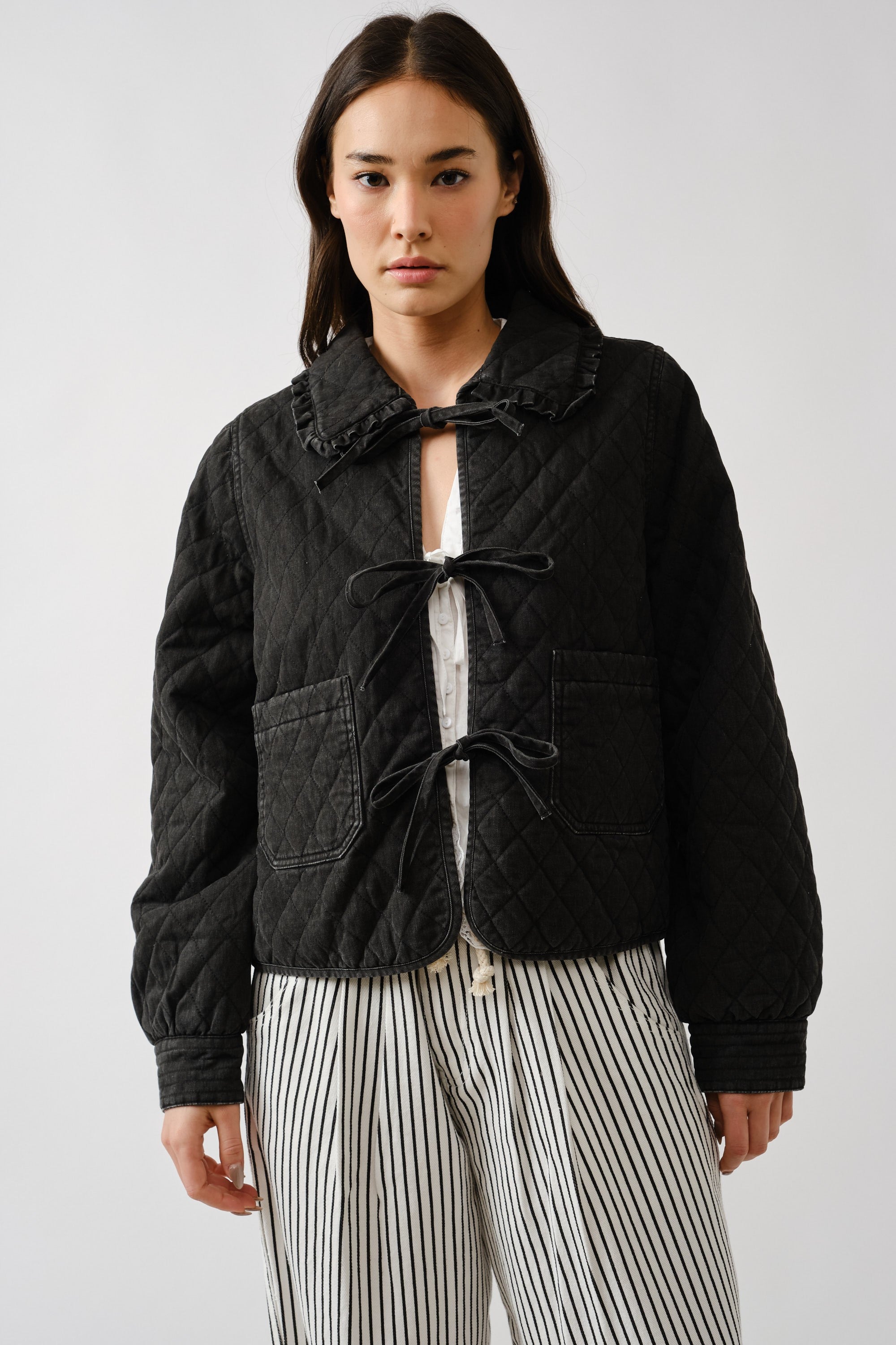 Chloe bow quilted denim jacket in black, front view