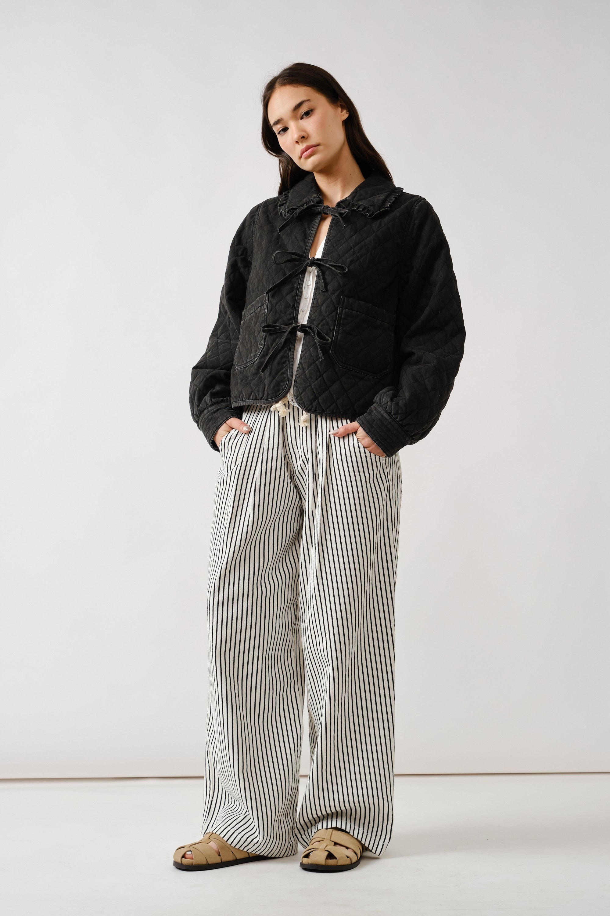 Chloe bow quilted denim jacket in black styled in a full outfit