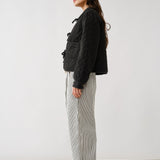 Chloe bow tie quilted denim jacket in black, side view