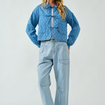 Full body view of Chloe Bow Quilted Denim Jacket in denim, styled casually with relaxed fit