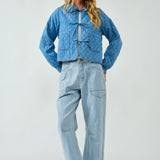 Full body view of Chloe Bow Quilted Denim Jacket in denim, styled casually with relaxed fit