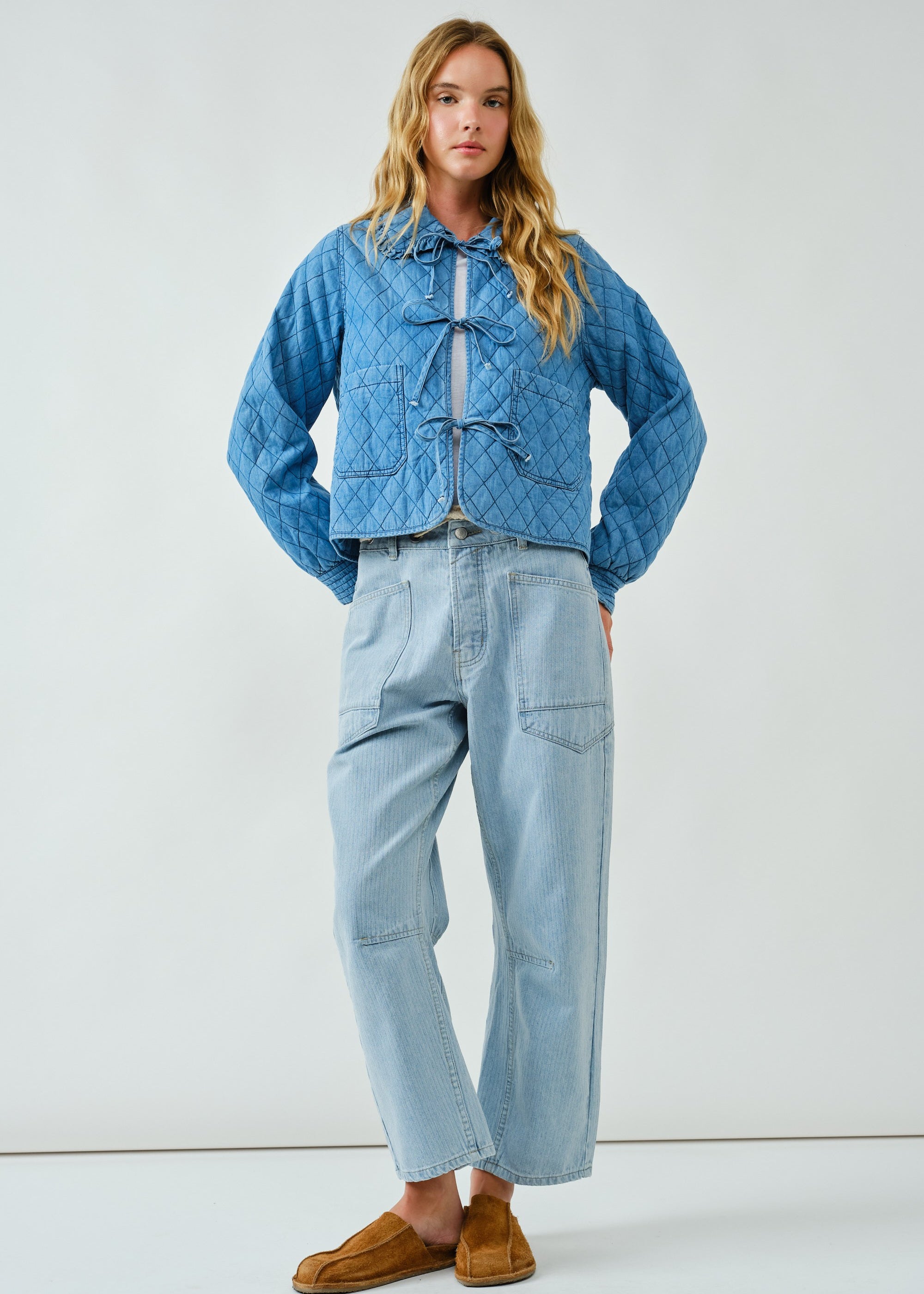 Full body view of Chloe Bow Quilted Denim Jacket in denim, styled casually with relaxed fit
