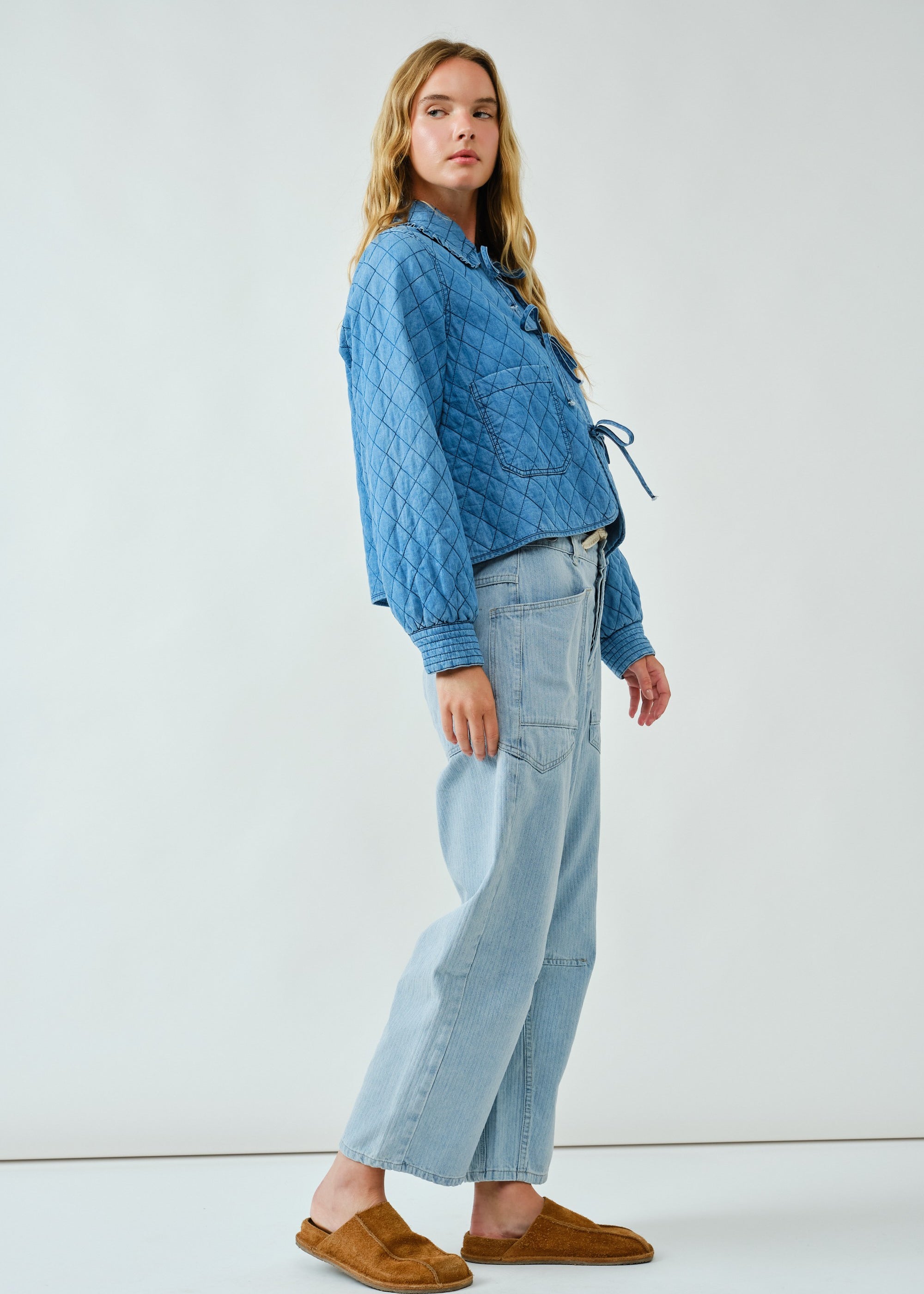 Angled view of Chloe Bow Quilted Denim Jacket styled for everyday casual wear