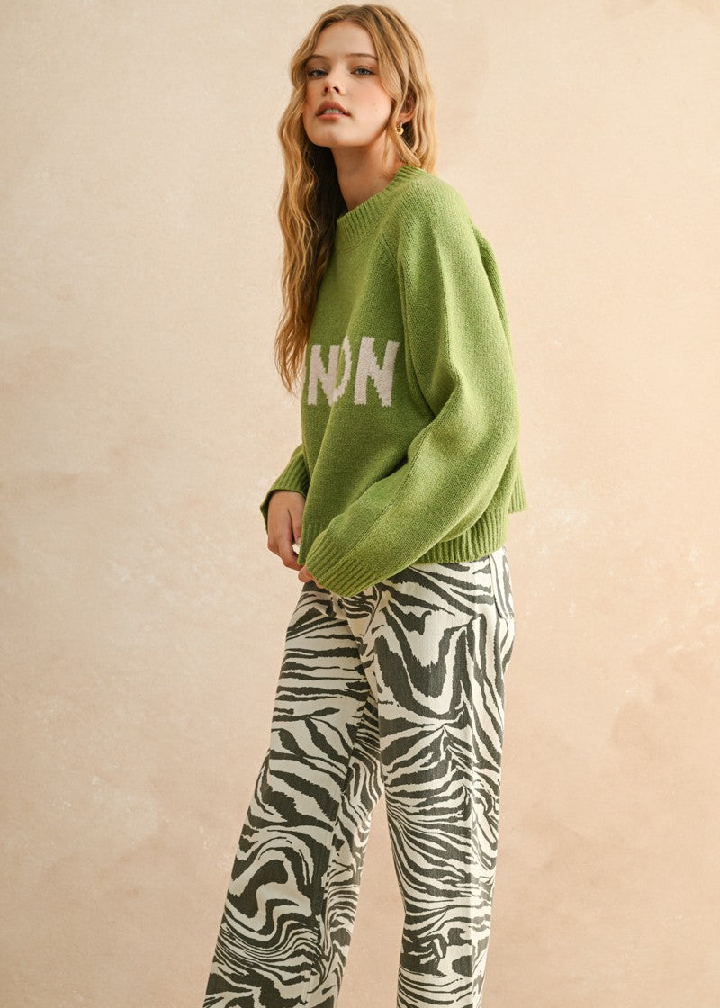 Side view of the City Print Casual Sweater in London green highlighting drape and silhouette