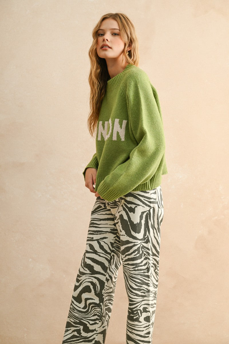 Side view of the City Print Casual Sweater in London green highlighting drape and silhouette