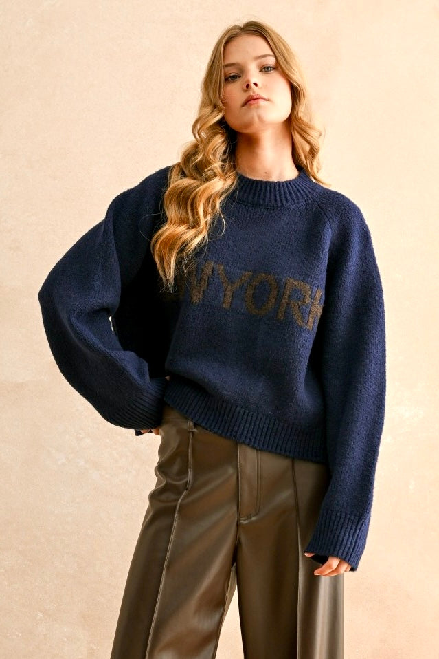 Front portrait of model wearing the City Print Casual Sweater in New York navy