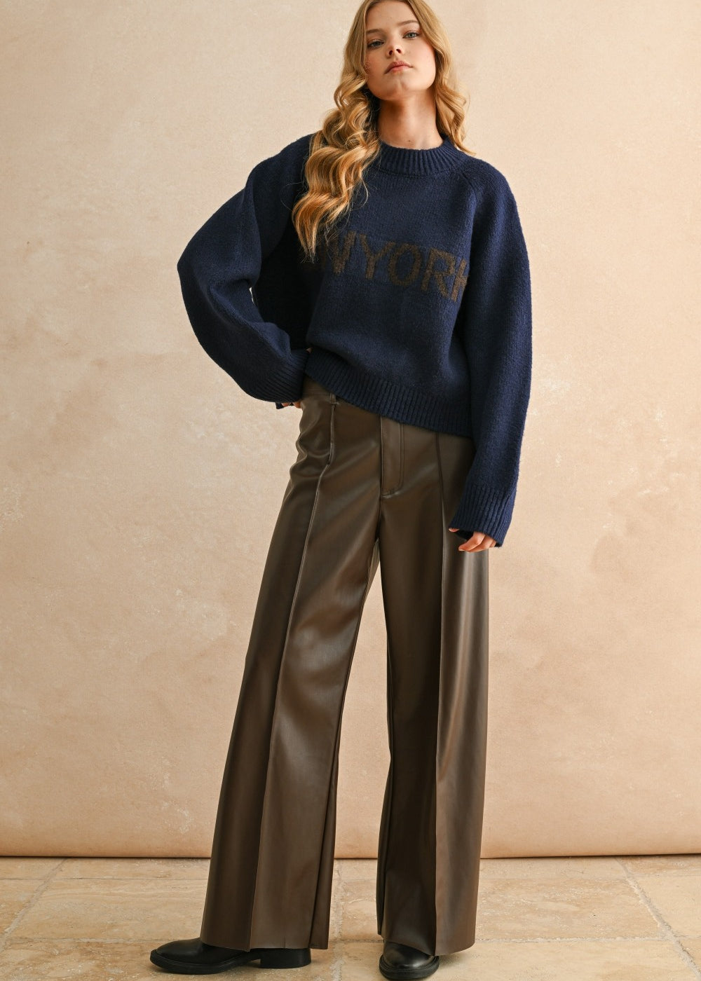 Full-body view of the New York navy city print sweater styled for an everyday casual look