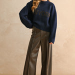 Full-body view of the New York navy city print sweater styled for an everyday casual look