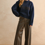 Full-body view of the New York navy city print sweater styled for an everyday casual look