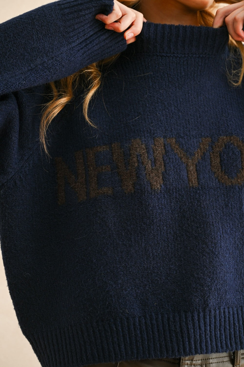Close-up detail of the New York city print on the navy casual sweater