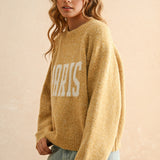 Angled front view of city print casual sweater in Paris butter