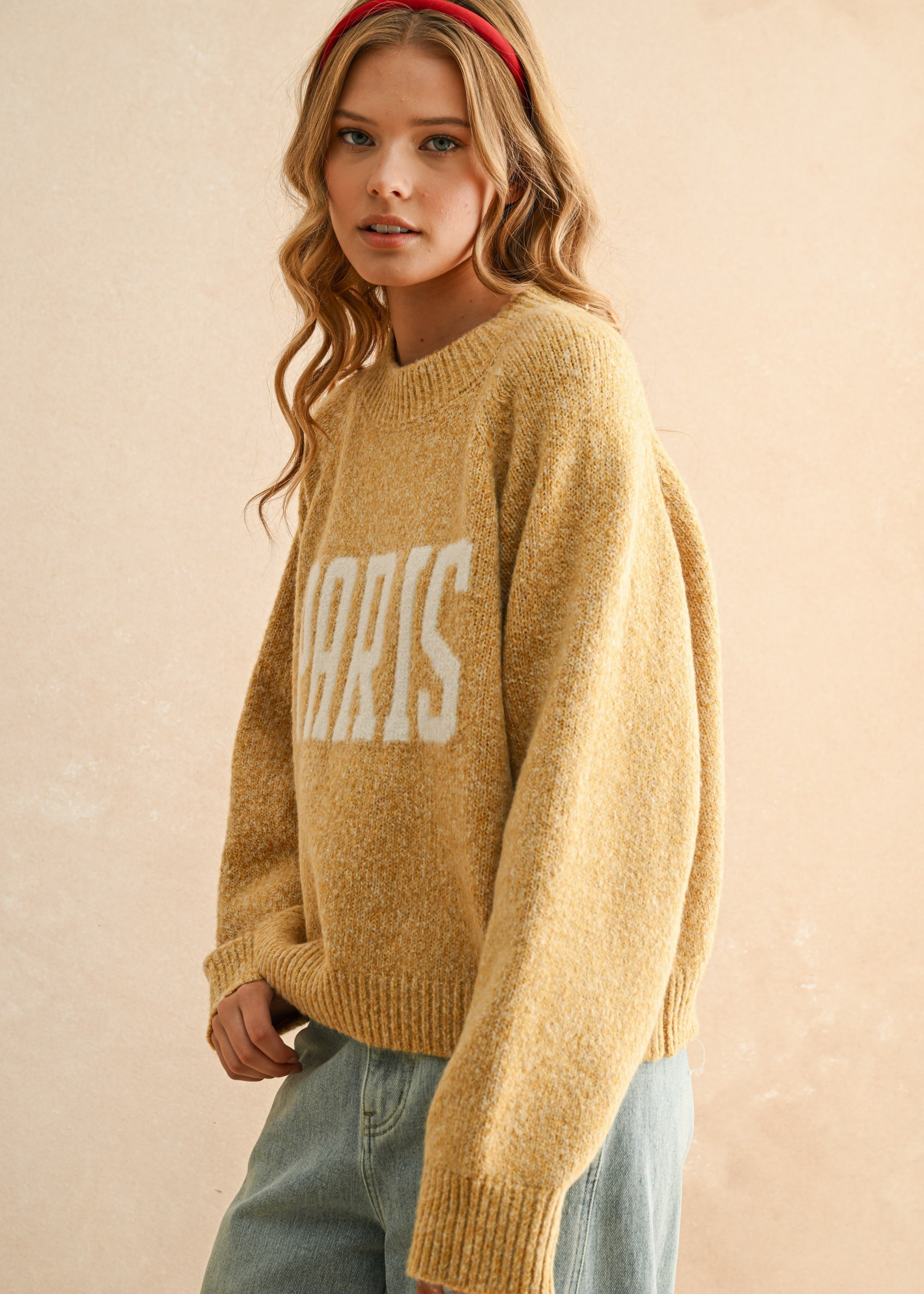 Angled front view of city print casual sweater in Paris butter