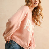 Angled view of city print casual sweater in Paris pink for everyday wear