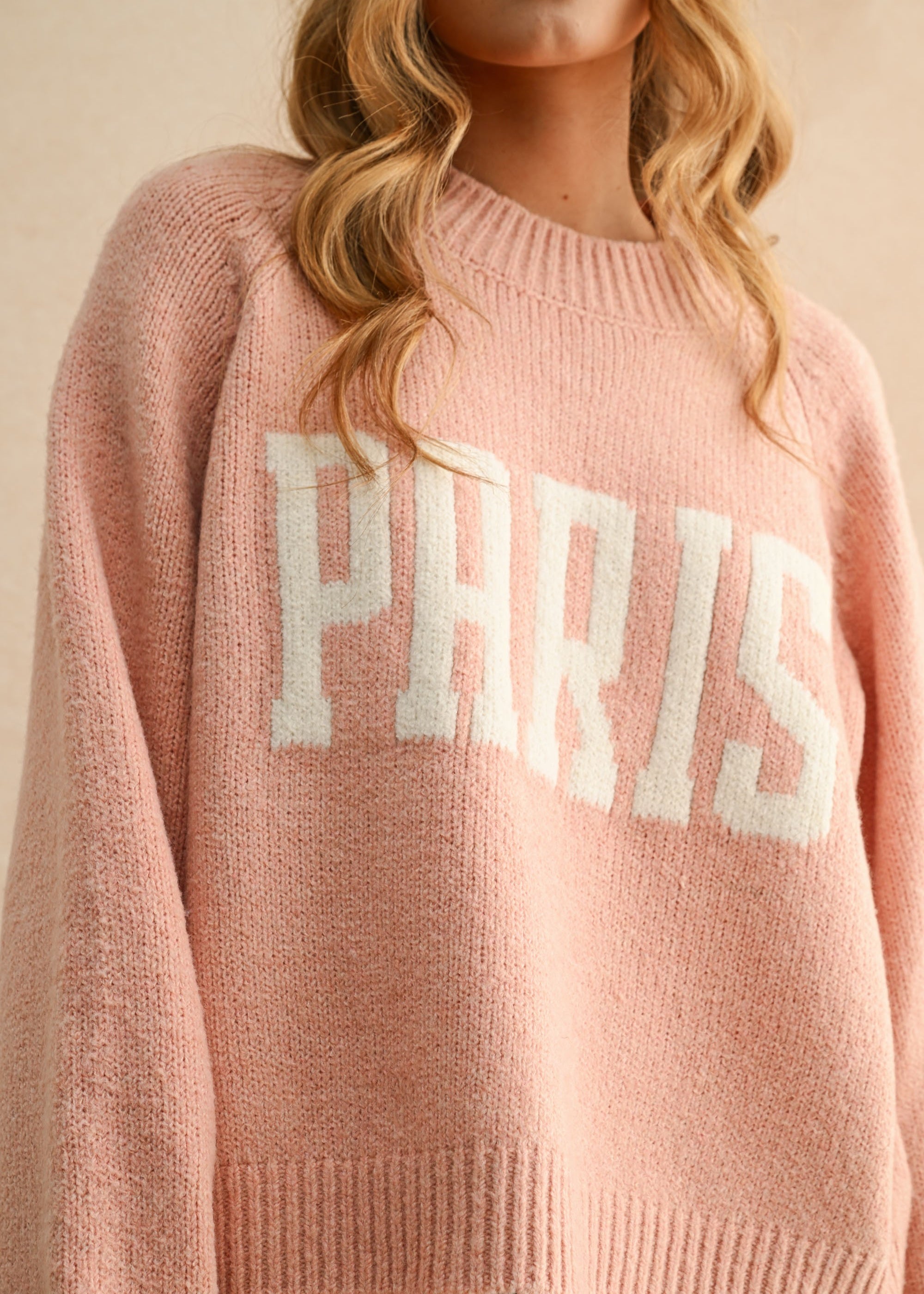 Close-up of Paris letter print on city print casual sweater in Paris pink