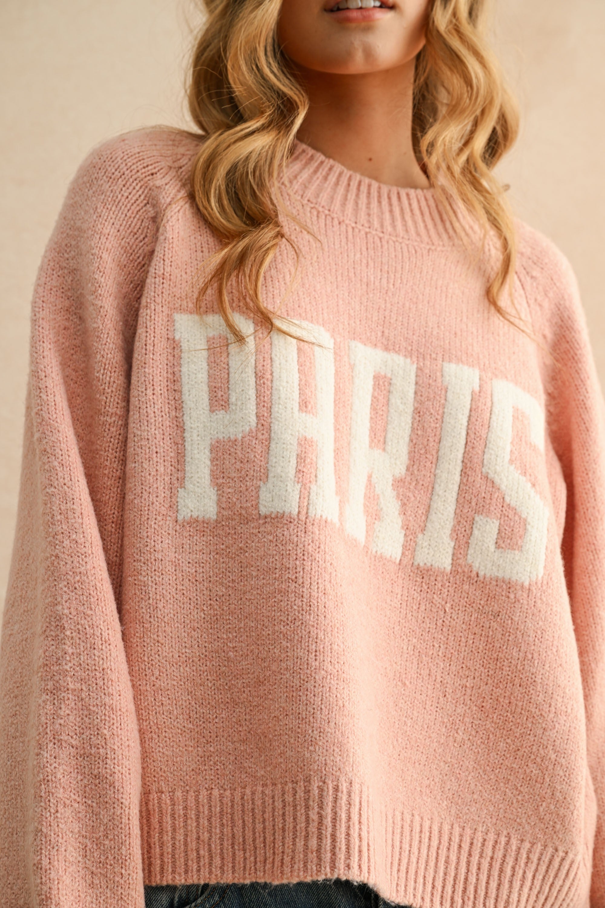 Close-up of Paris letter print on city print casual sweater in Paris pink