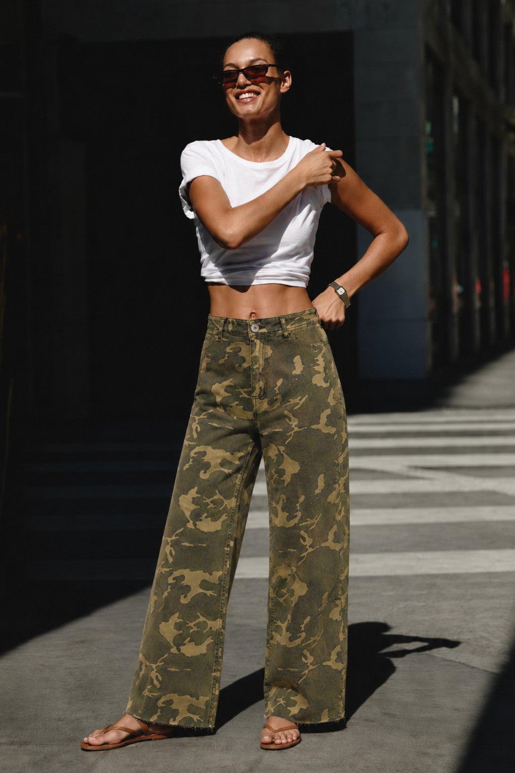 Camouflage wide leg denim pants styled with a simple top for an easy everyday outfit.