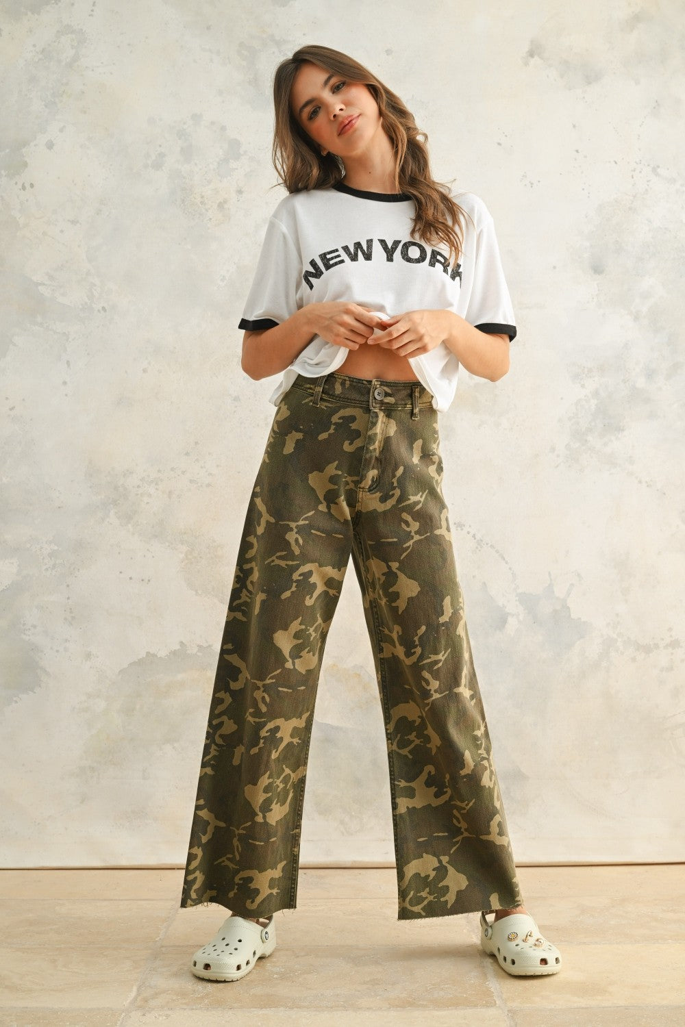 Camouflage wide leg denim pants styled with a simple top for an easy everyday outfit.