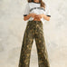 Camouflage wide leg denim pants styled with a simple top for an easy everyday outfit.
