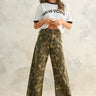 Camouflage wide leg denim pants styled with a simple top for an easy everyday outfit.