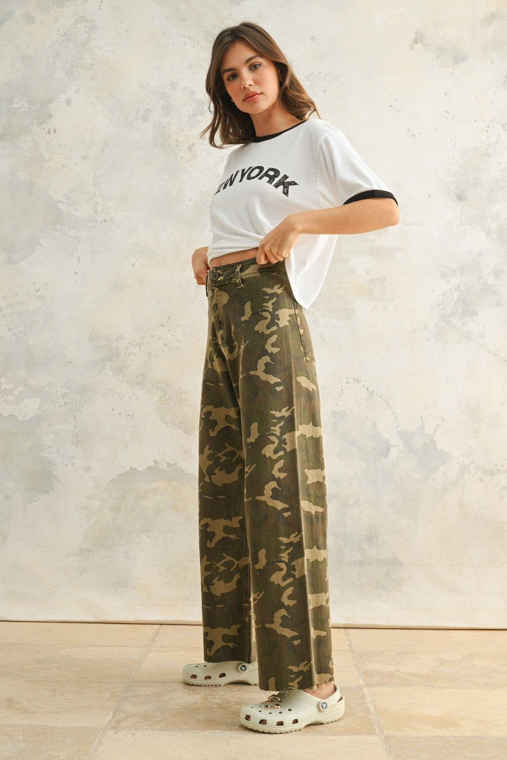 Side view of Colette camouflage wide leg denim pants with a relaxed fit, stretch denim fabric, and raw hem finish