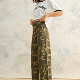 Side view of Colette camouflage wide leg denim pants with a relaxed fit, stretch denim fabric, and raw hem finish