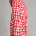 side view of Colette wide-leg gingham pants in red with a high-rise waist and raw hem - closer