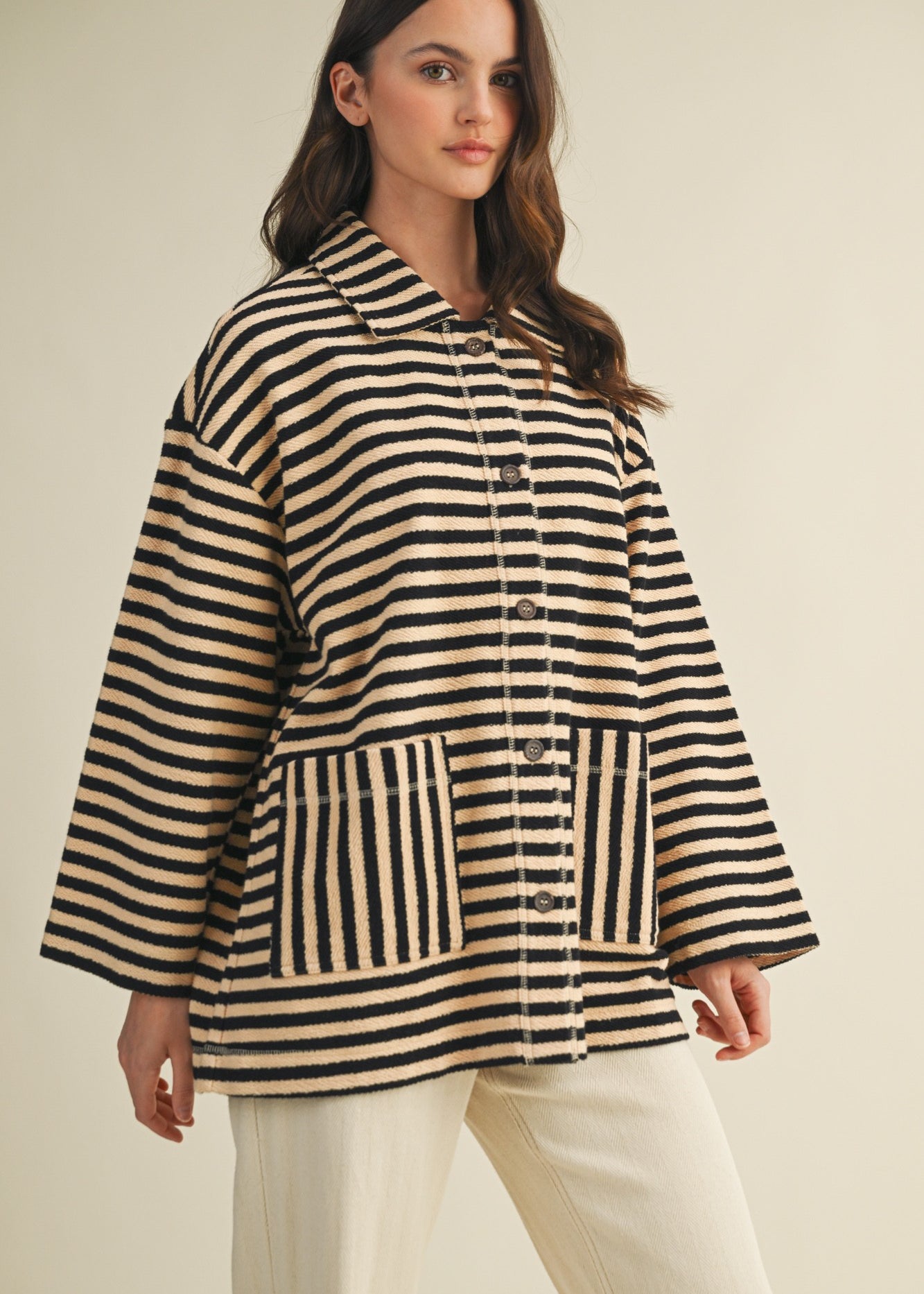 Angled front view of cozy in stripes button-up jacket with relaxed oversized silhouette