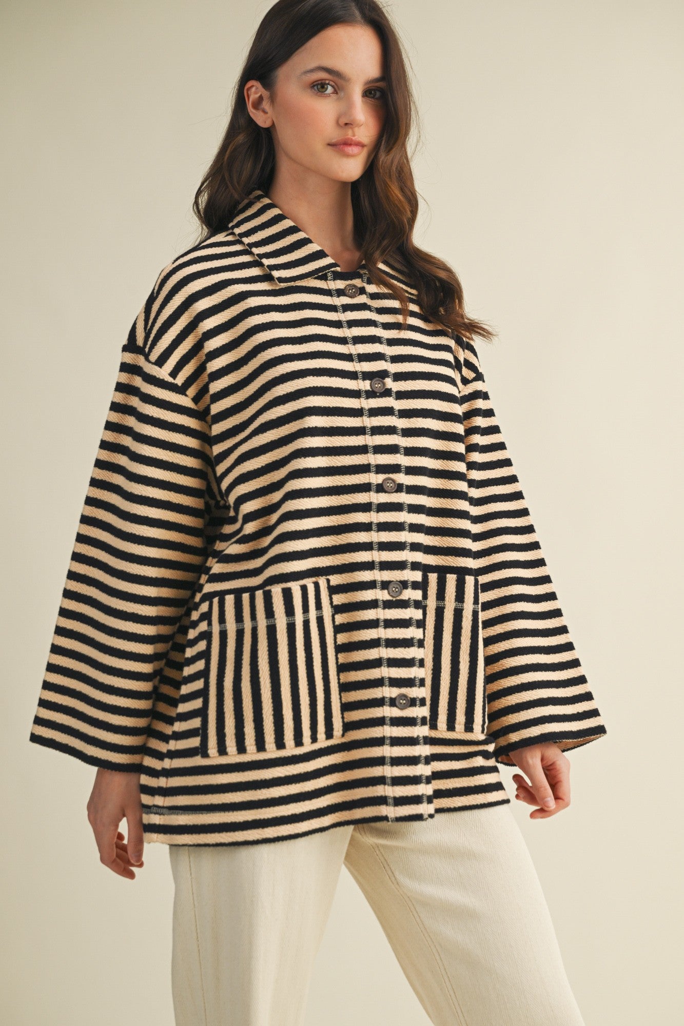 Angled front view of cozy in stripes button-up jacket with relaxed oversized silhouette