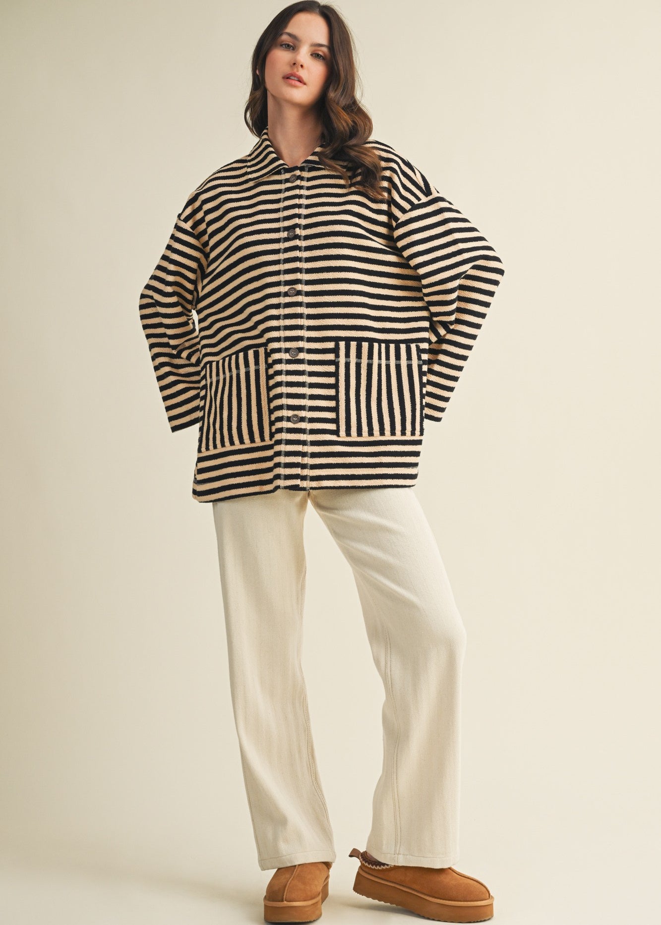 Full body view of cozy in stripes button-up jacket styled casually in black combo