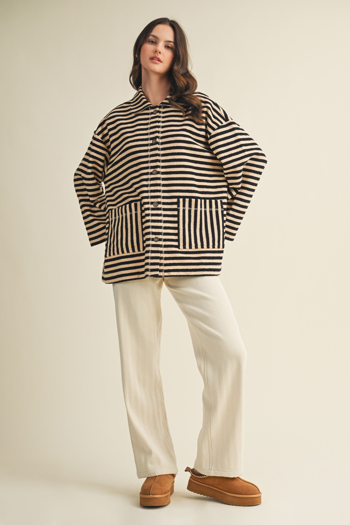Full body view of cozy in stripes button-up jacket styled casually in black combo