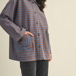 Angled front view of cozy in stripes button-up jacket with relaxed oversized silhouette