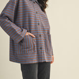 Angled front view of cozy in stripes button-up jacket with relaxed oversized silhouette