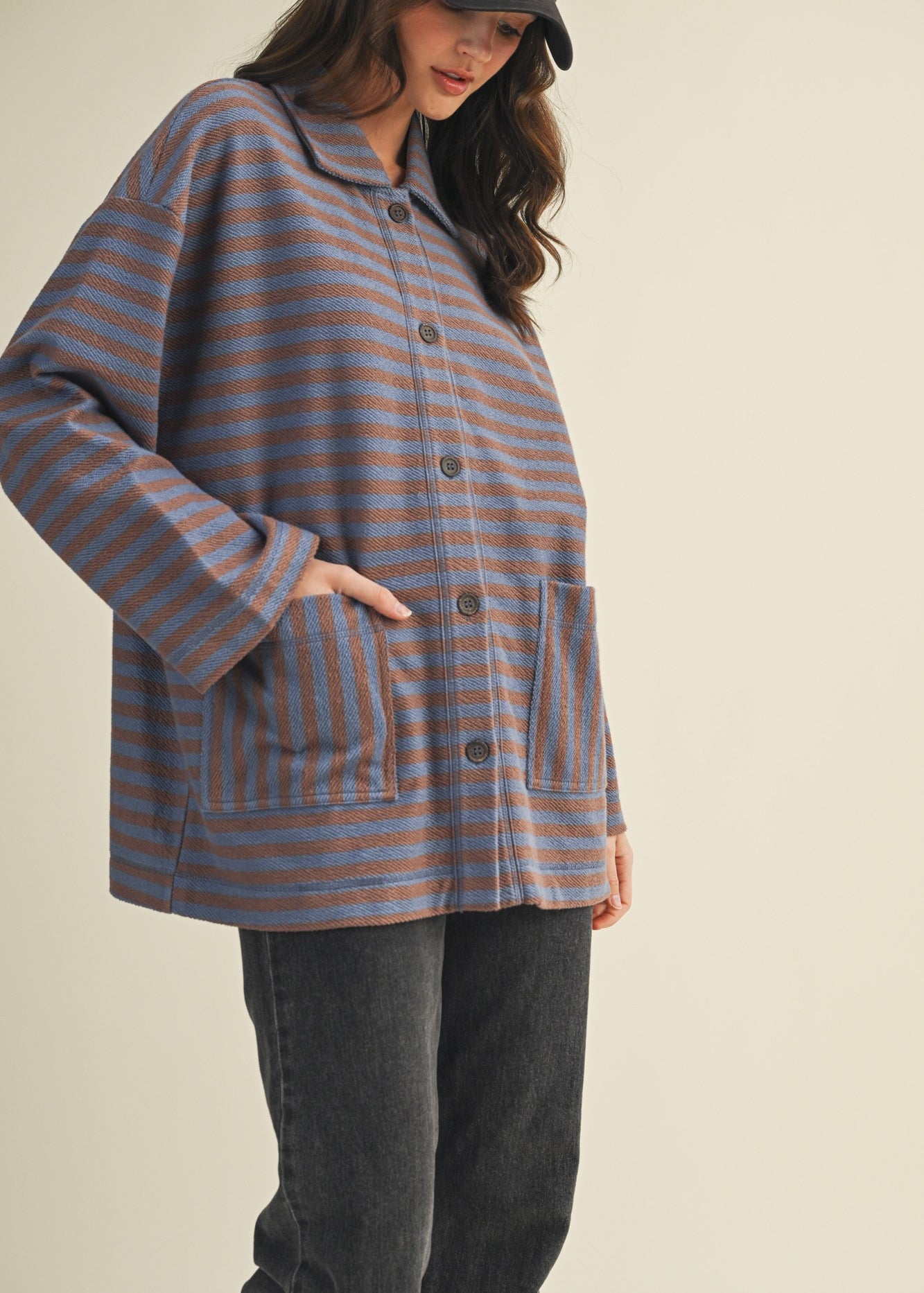 Angled front view of cozy in stripes button-up jacket with relaxed oversized silhouette