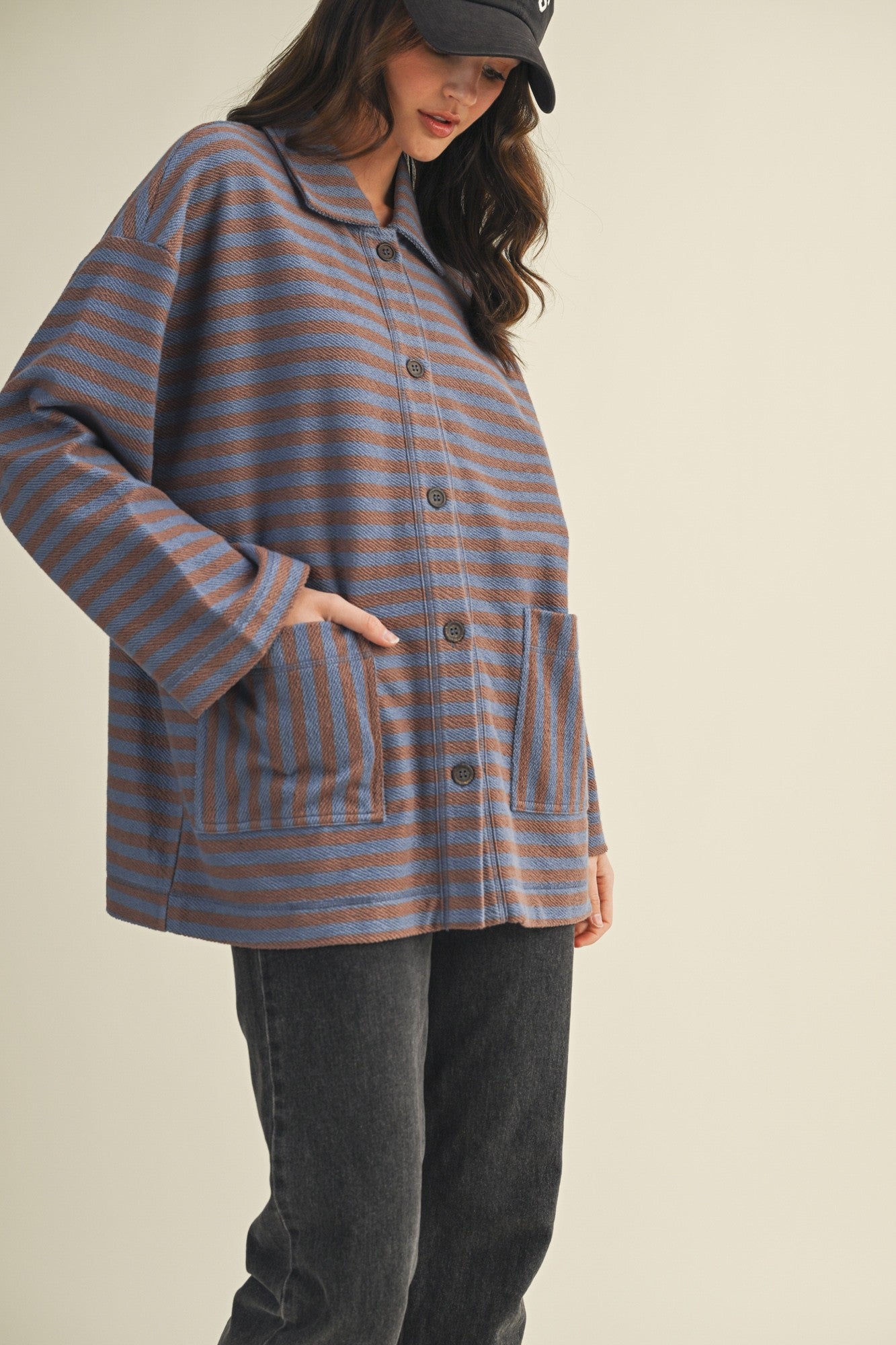 Angled front view of cozy in stripes button-up jacket with relaxed oversized silhouette