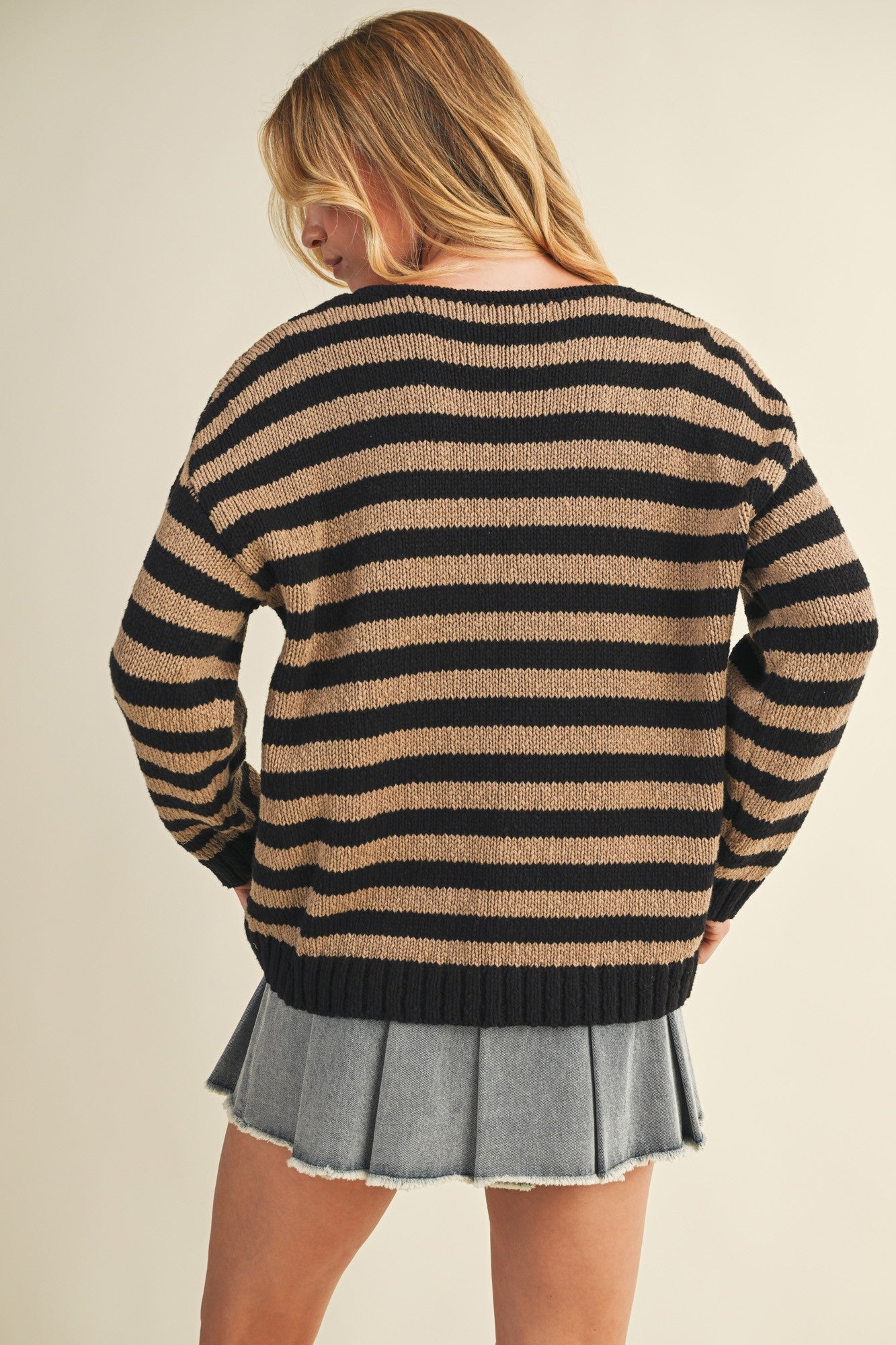 Back view of cozy stripe v neck pullover in black and mocha