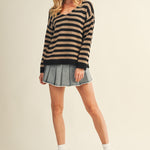 Full body view of cozy stripe v neck pullover styled casually in black and mocha