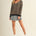 Full body view of cozy stripe v neck pullover styled casually in black and mocha