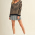 Full body view of cozy stripe v neck pullover styled casually in black and mocha