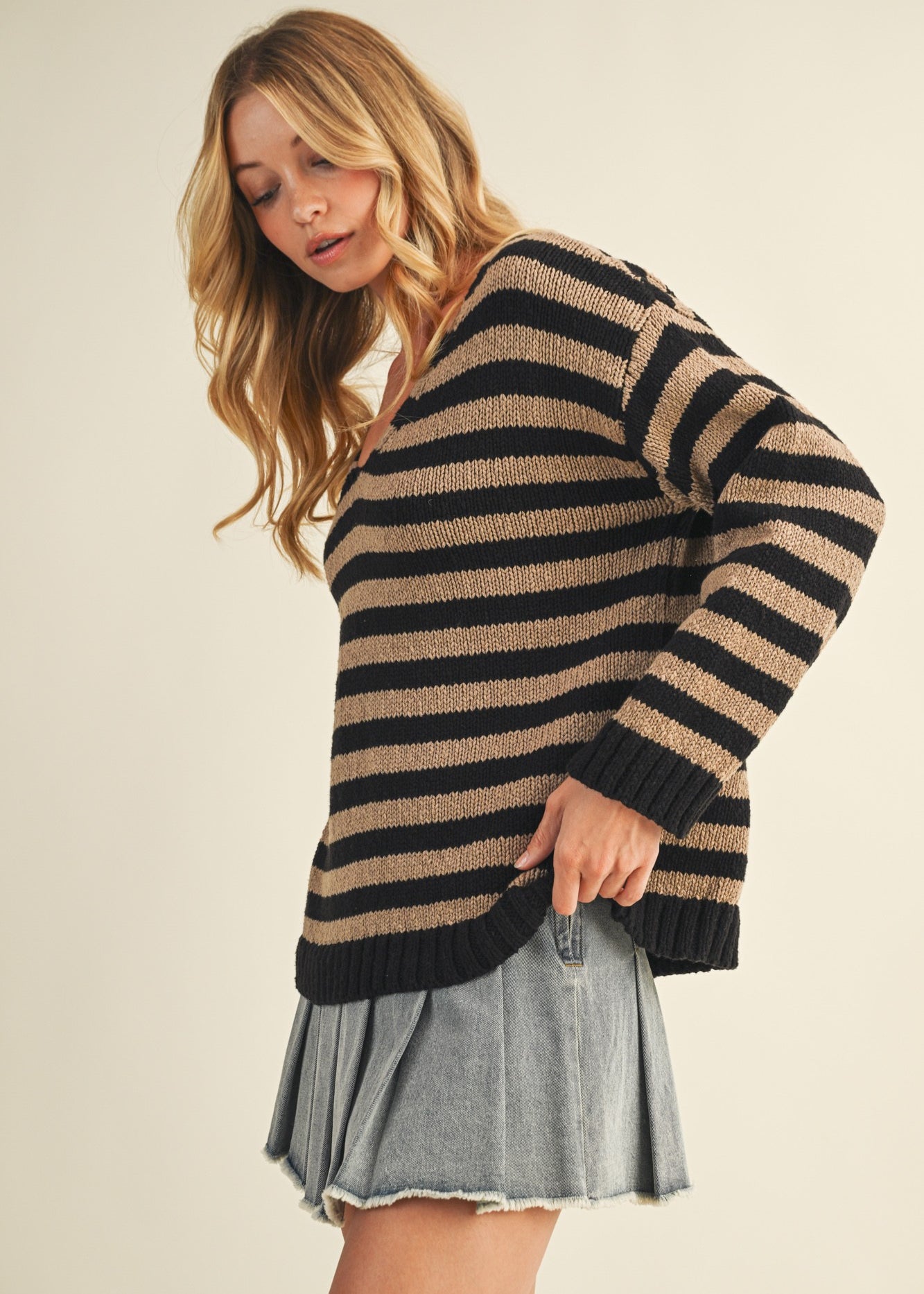 Side view of cozy stripe v neck pullover showing relaxed silhouette