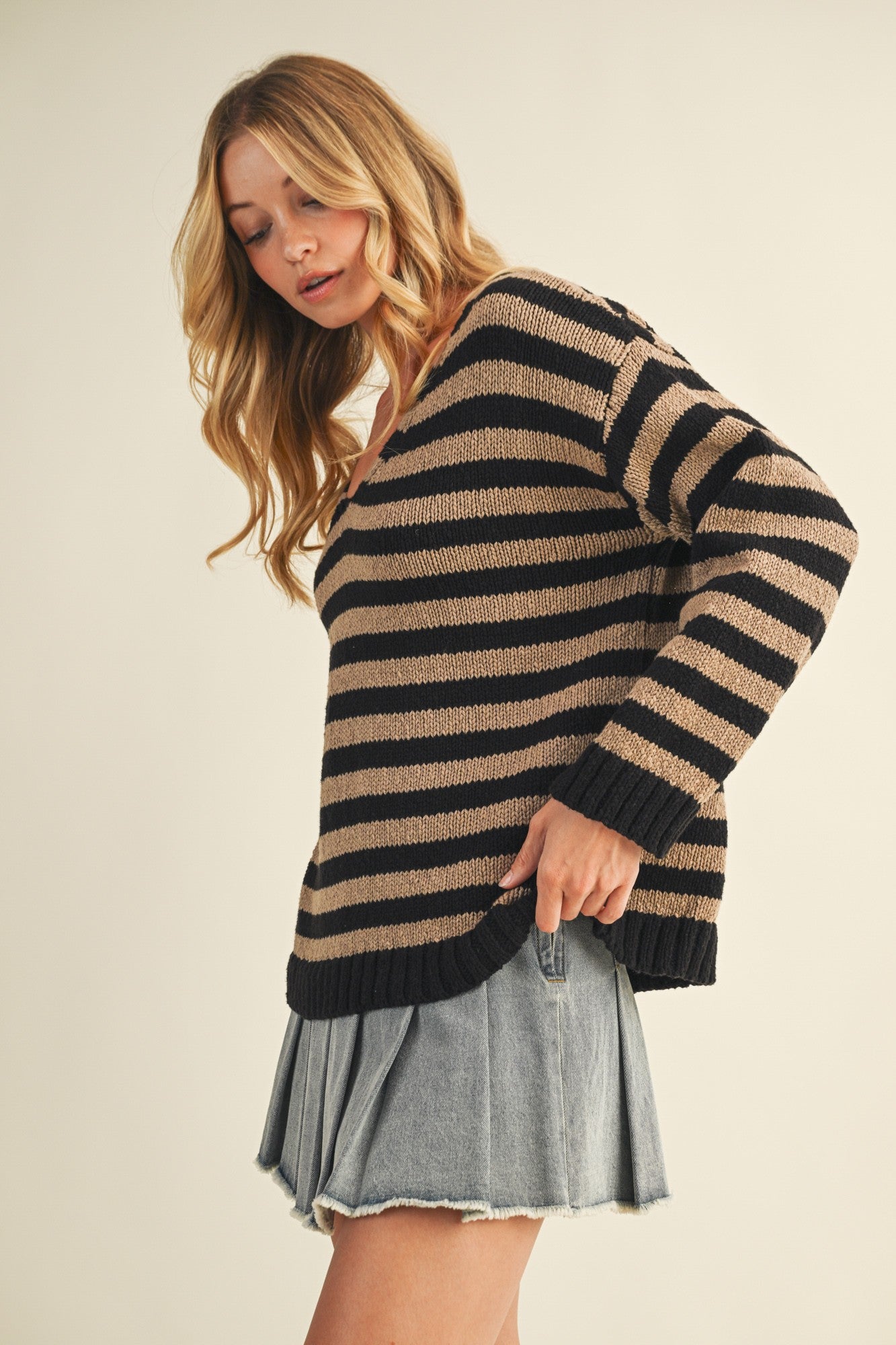 Side view of cozy stripe v neck pullover showing relaxed silhouette