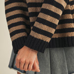 Close-up of sleeve and ribbed cuff on cozy stripe v neck pullover in black and mocha