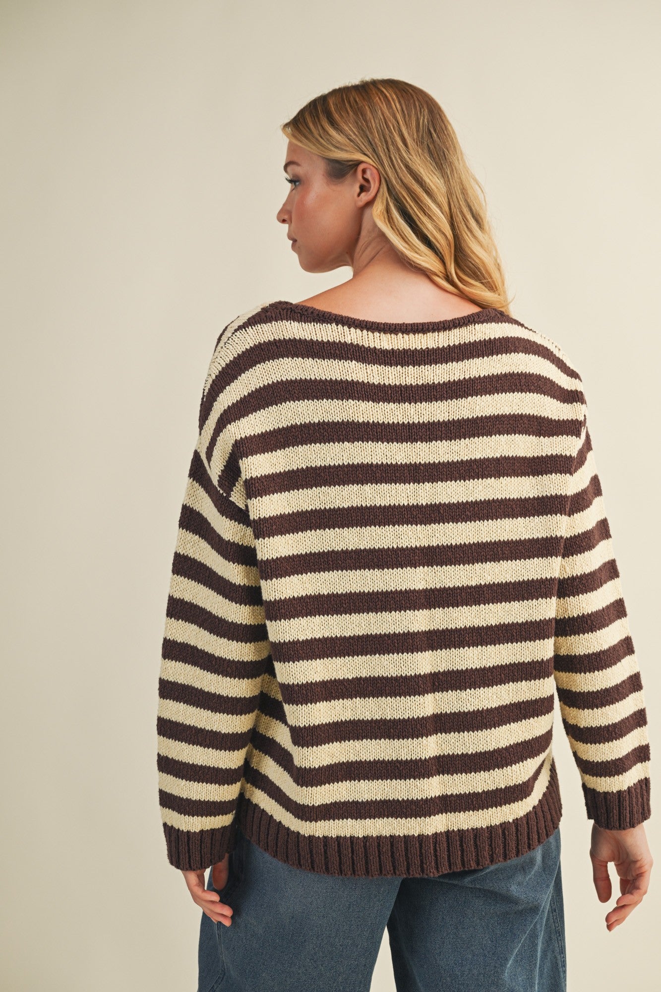 Back view of cozy stripe v neck pullover in brown and ivory