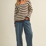 Full body view of cozy stripe v neck pullover styled with wide-leg jeans