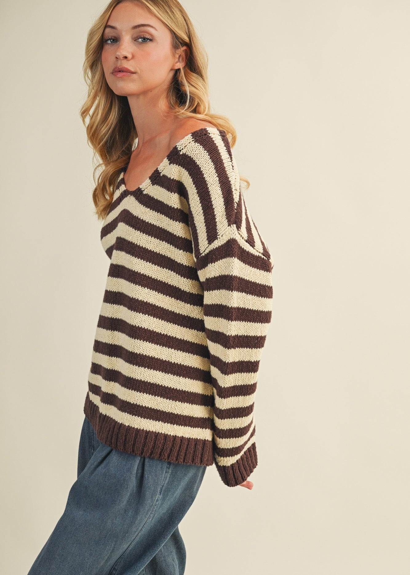 Side view of cozy stripe v neck pullover showing relaxed silhouette