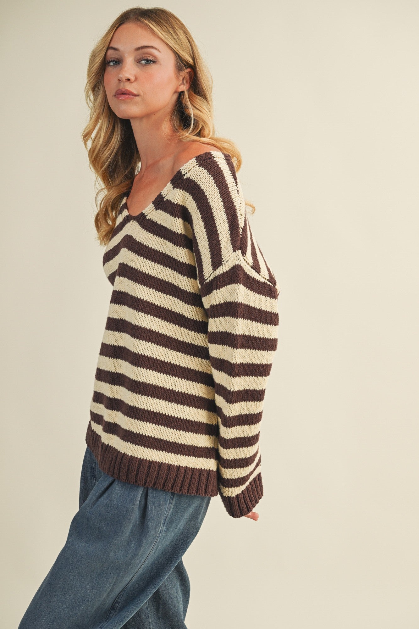 Side view of cozy stripe v neck pullover showing relaxed silhouette