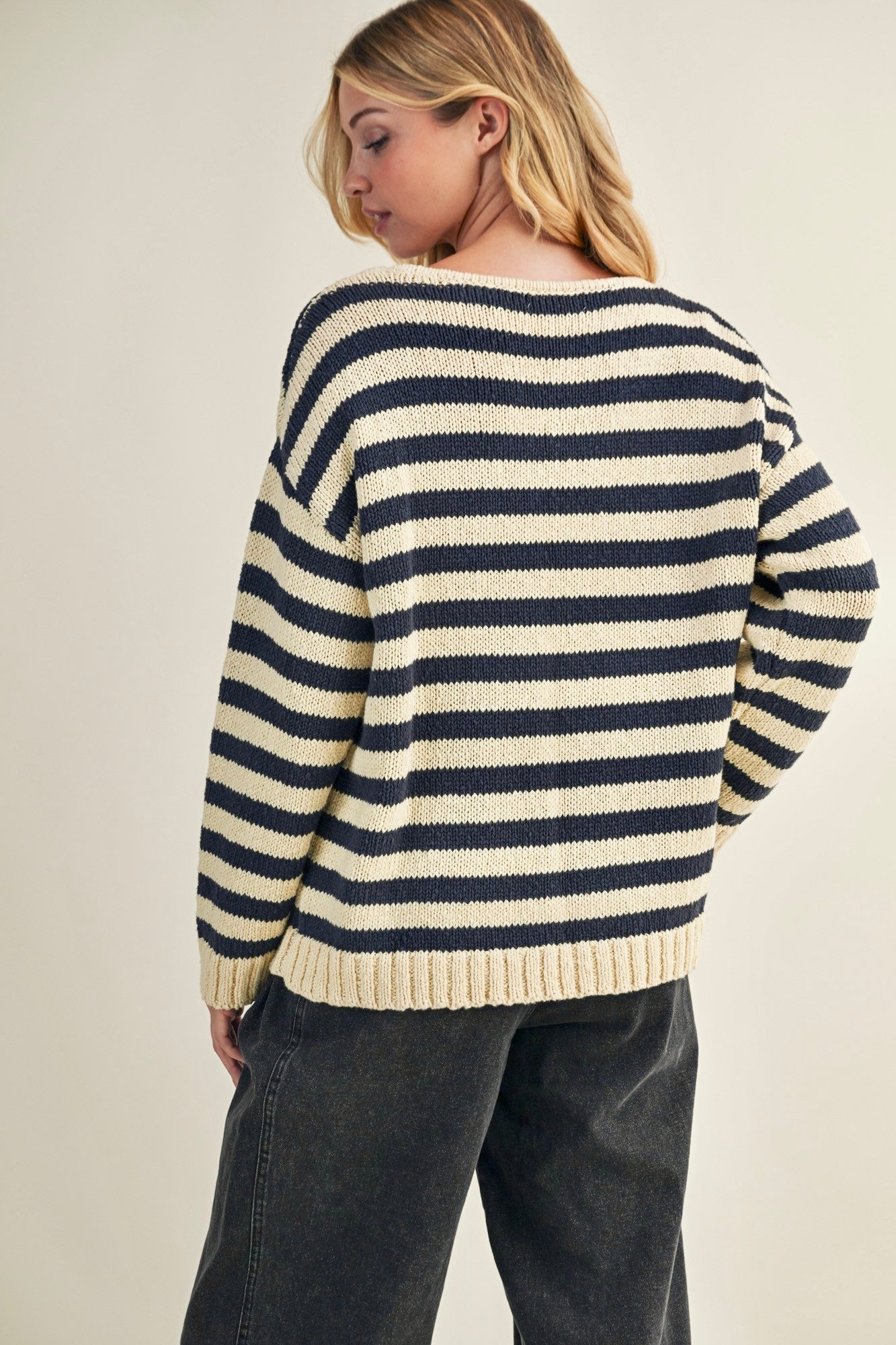 Back view of cozy stripe v neck pullover in navy and ivory