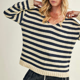 Woman wearing a striped sweater with a neutral background